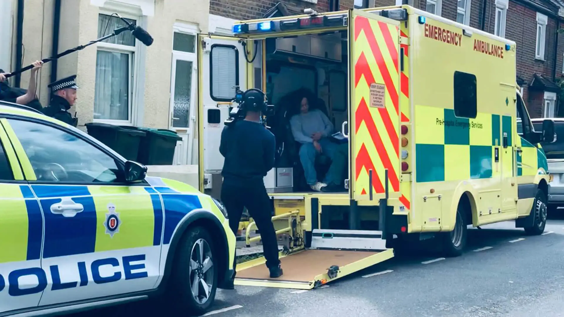 A film crew filming a lady in an ambulance with a police car behind it, the film crew behind the scenes of Lesley, a film based on Santan Dave's Lesley by MotionRay Pictures.